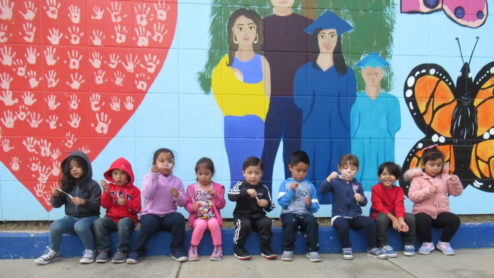 Group of kids in front of mural-widescreen